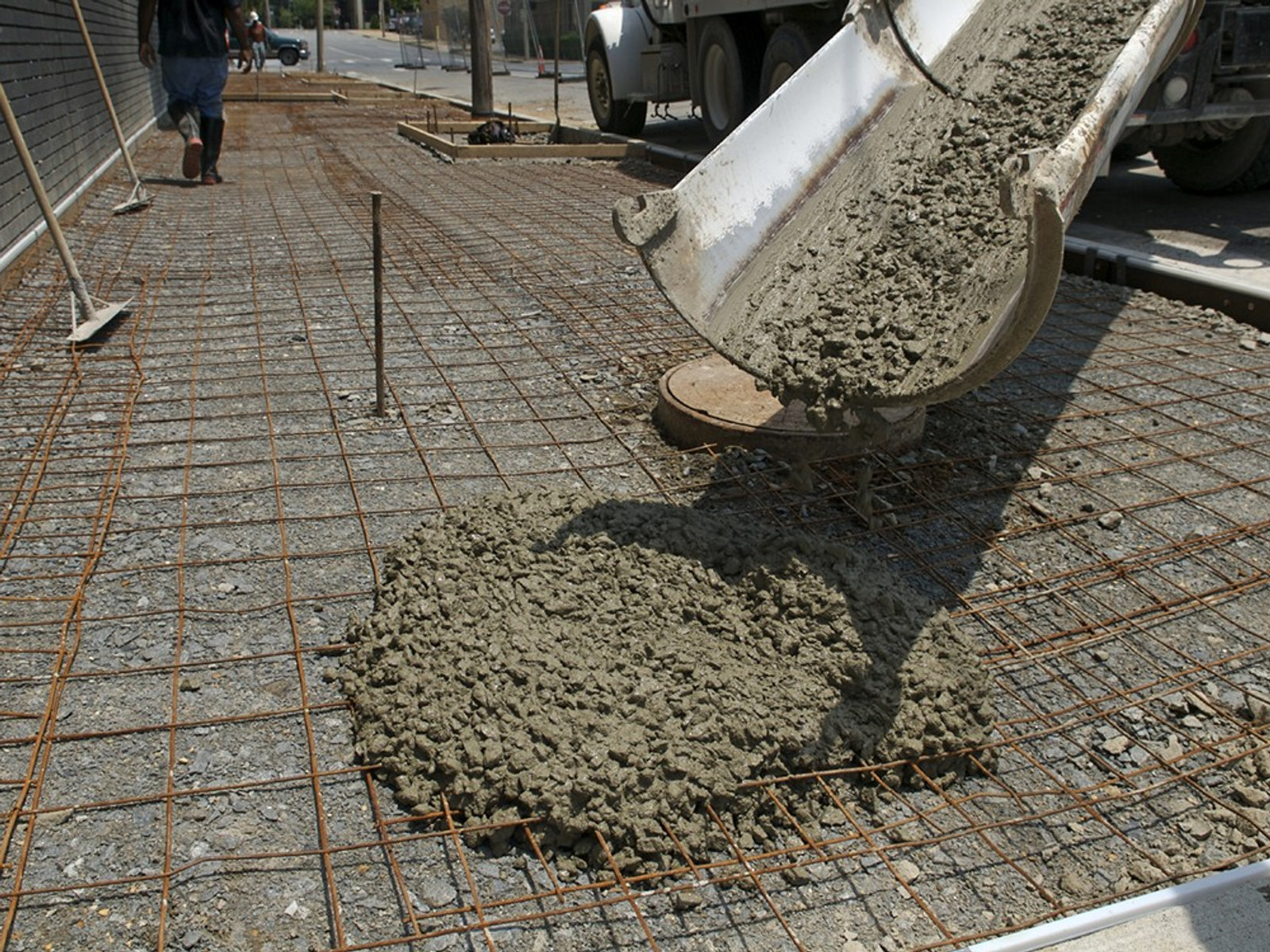 Freshly poured concrete driveway apron with granite border